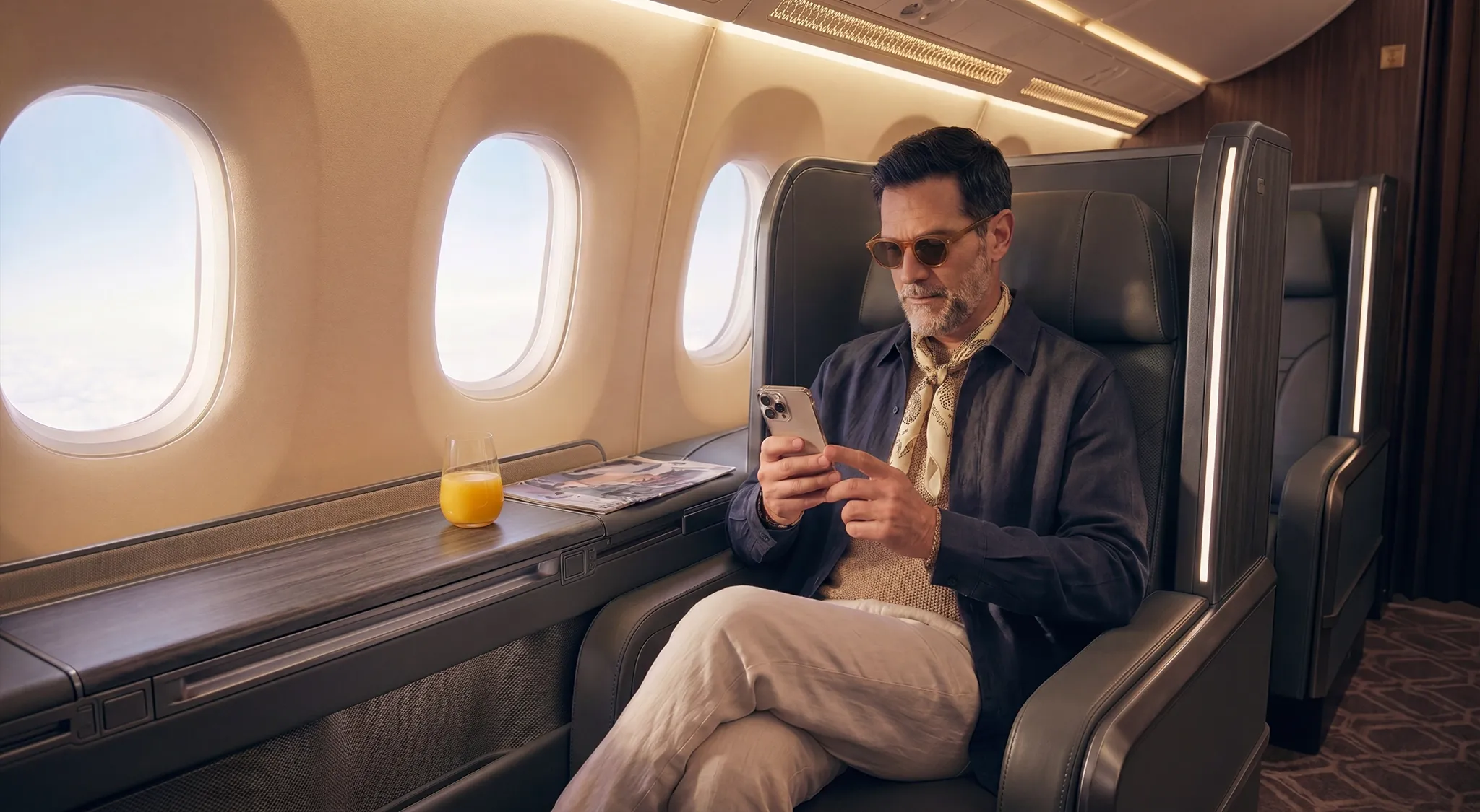 A man on an airplane using his cell phone and working with a travel VPN