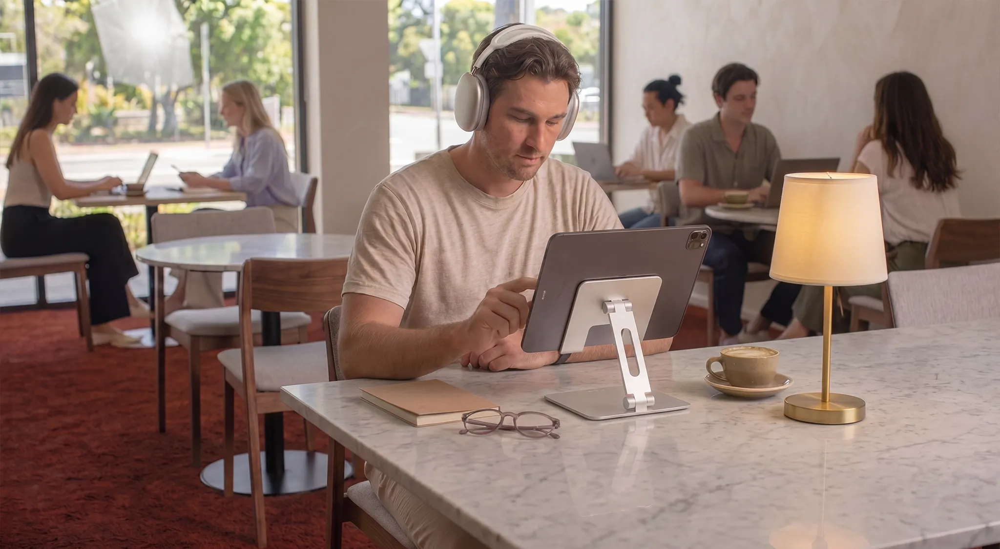 A freelancer sitting in a cafe and working with his iPad